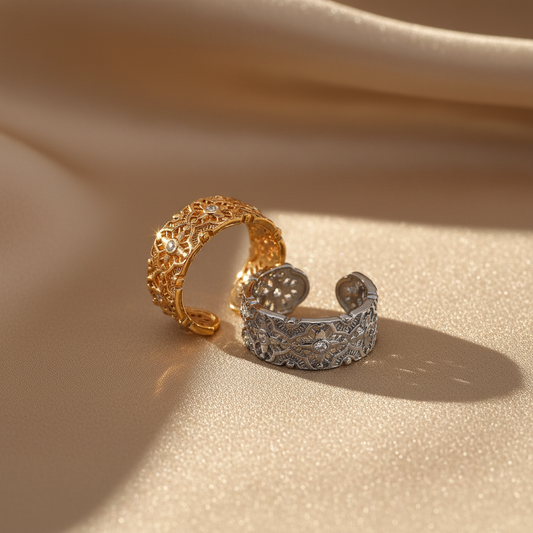 Gold and silver rings on silky beige fabric warm tones